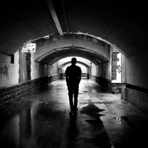 silhouette photo of a man in a tunnel