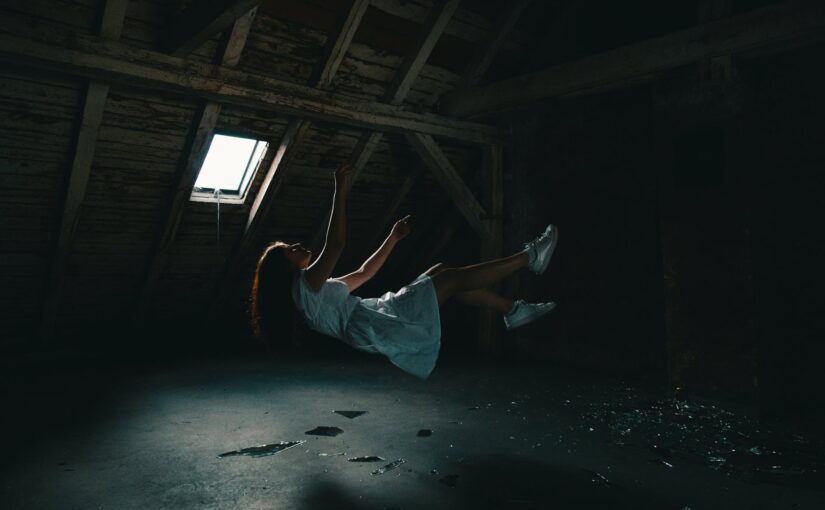 woman in white dress falling on gray concrete floor
