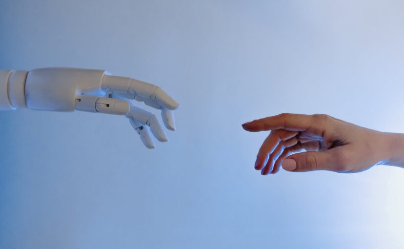 person reaching out to a robot